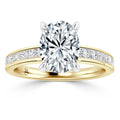 Gold ring with a large oval diamond center and square side diamonds set along the band, on white background.