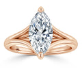 Rose gold ring with a split shank and a large marquise-cut diamond set in the center, on a white background.