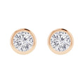 Pair of round diamond stud earrings set in simple yellow gold bezel settings, displayed on a white background.