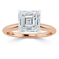 A rose gold ring with a large square-cut diamond set in a four-prong solitaire setting.