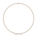 A delicate gold tennis necklace set with small, round white diamonds in a continuous circle, clasp at top.