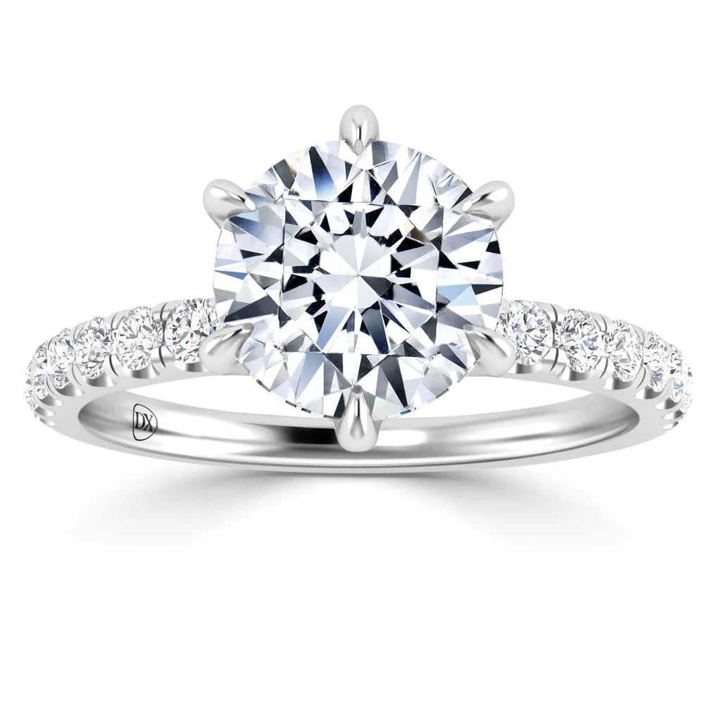 White gold ring with a large round diamond center stone and smaller diamonds on the band.