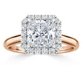 Rose gold ring with a large square-cut diamond, surrounded by a halo of smaller round diamonds.