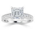 White gold ring with a large Asscher-cut diamond and smaller diamonds set along the band.
