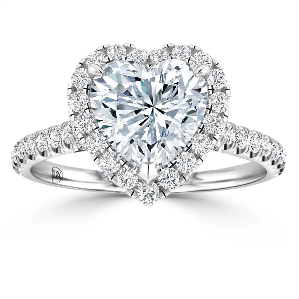 A heart-shaped diamond ring with a pavé diamond halo on a white gold band set with small diamonds.