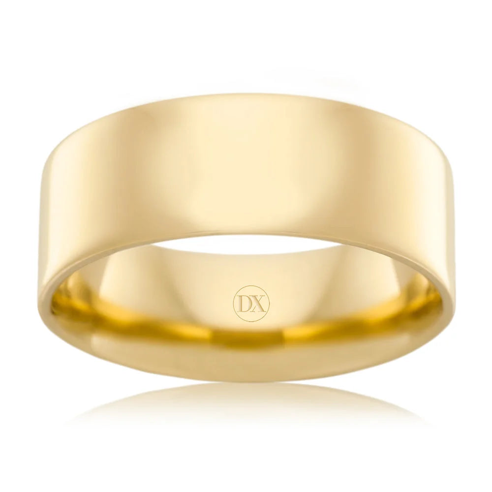 A plain, wide gold band ring with a shiny finish and subtle DX engraving inside.
