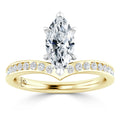 Gold ring with a marquise-cut diamond center and a band set with round diamonds on a white background.