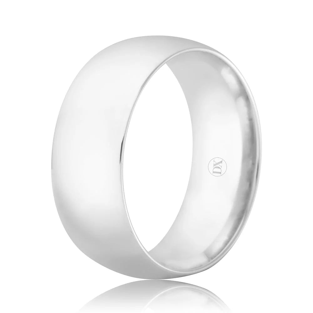 A plain, wide, polished silver ring with a smooth surface and a small engraved logo inside the band.