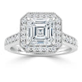 Asscher-cut diamond ring with double halo and pavé diamonds on a white gold band, seen from the front.