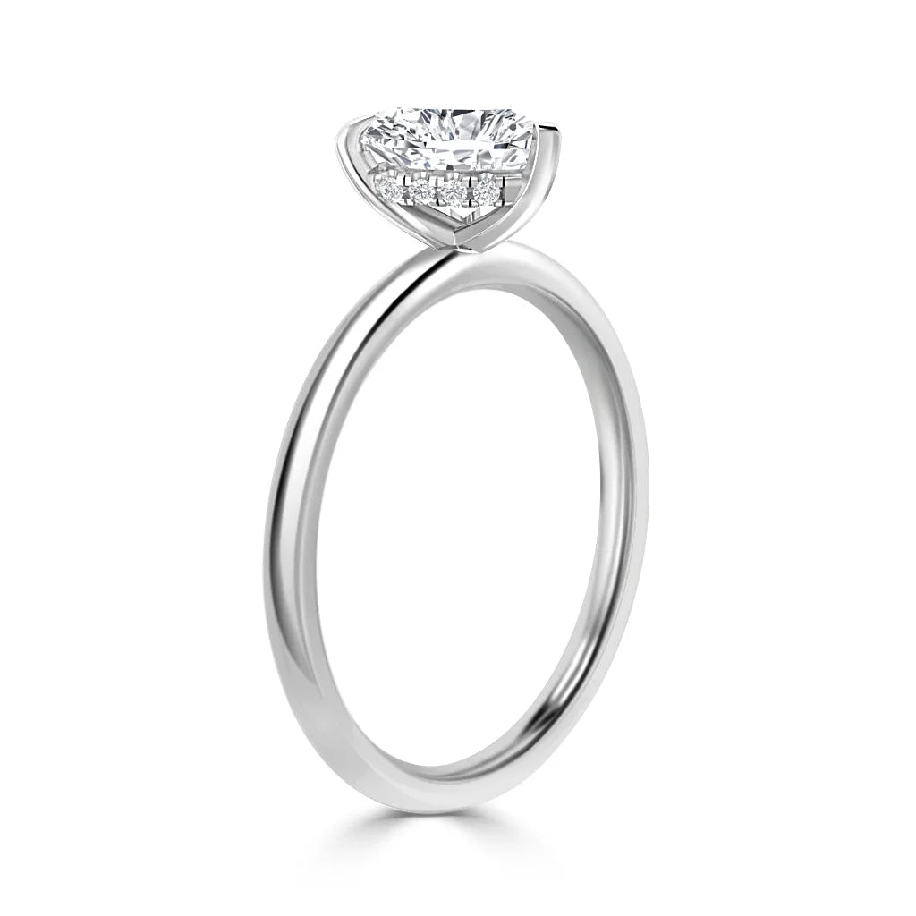 A silver solitaire ring with a heart-shaped diamond set in a minimalist, elegant prong setting.