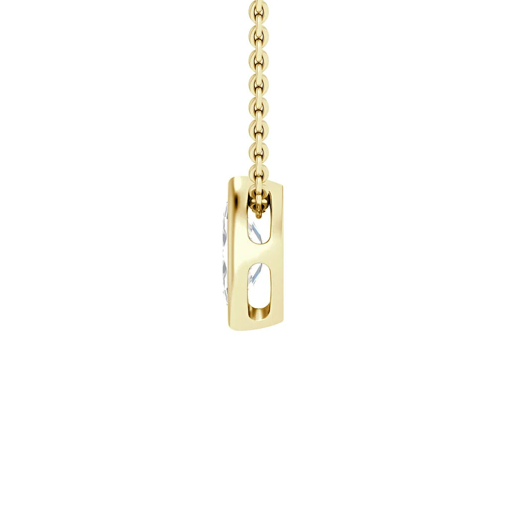 Gold chain with a rectangular gold pendant featuring open sides and a clear gemstone set in the center.