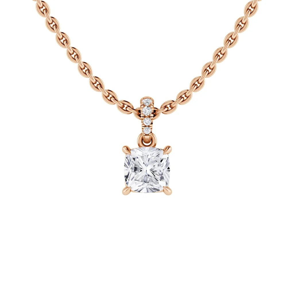 A rose gold chain necklace with a square diamond pendant and small round diamonds above the main stone.