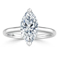 A marquise-cut diamond solitaire ring with a thin, polished white gold band shown on a white background.