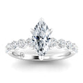 A marquise-cut diamond ring with round side stones set in a polished white metal band.