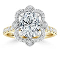 Gold ring with an oval diamond center, floral diamond halo, and diamonds set along the band.