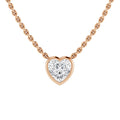 A gold chain necklace with a heart-shaped diamond pendant set in a gold bezel, on a white background.