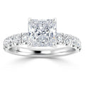 Platinum ring with a large princess-cut diamond center and smaller round diamonds set along the band.