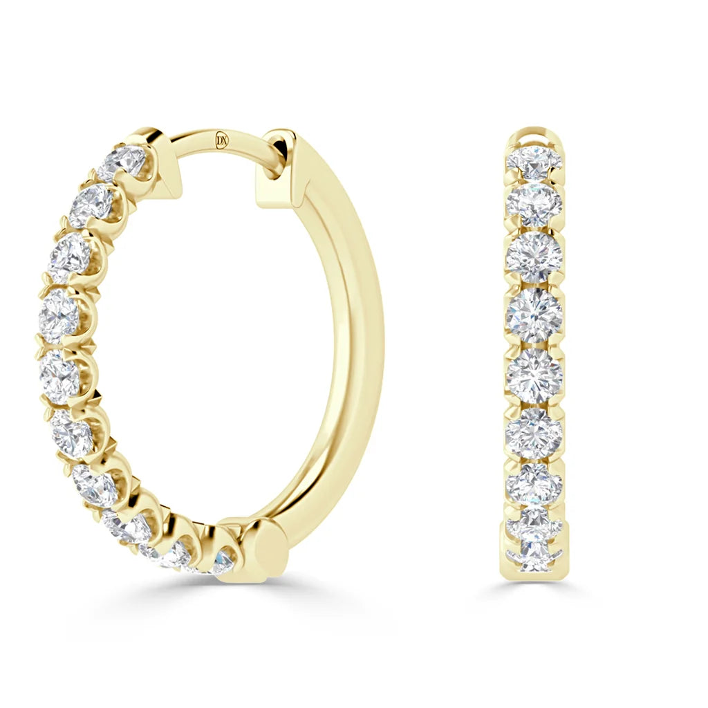 Gold hoop earrings adorned with a row of round white diamonds set along the front and outer edge.