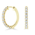 Gold hoop earrings adorned with a row of round white diamonds set along the front and outer edge.