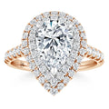 Pear-shaped diamond ring with double halo and pavé band in rose gold, sparkling with many small round diamonds.