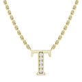 Gold chain necklace with a diamond-studded letter T pendant on a white background.