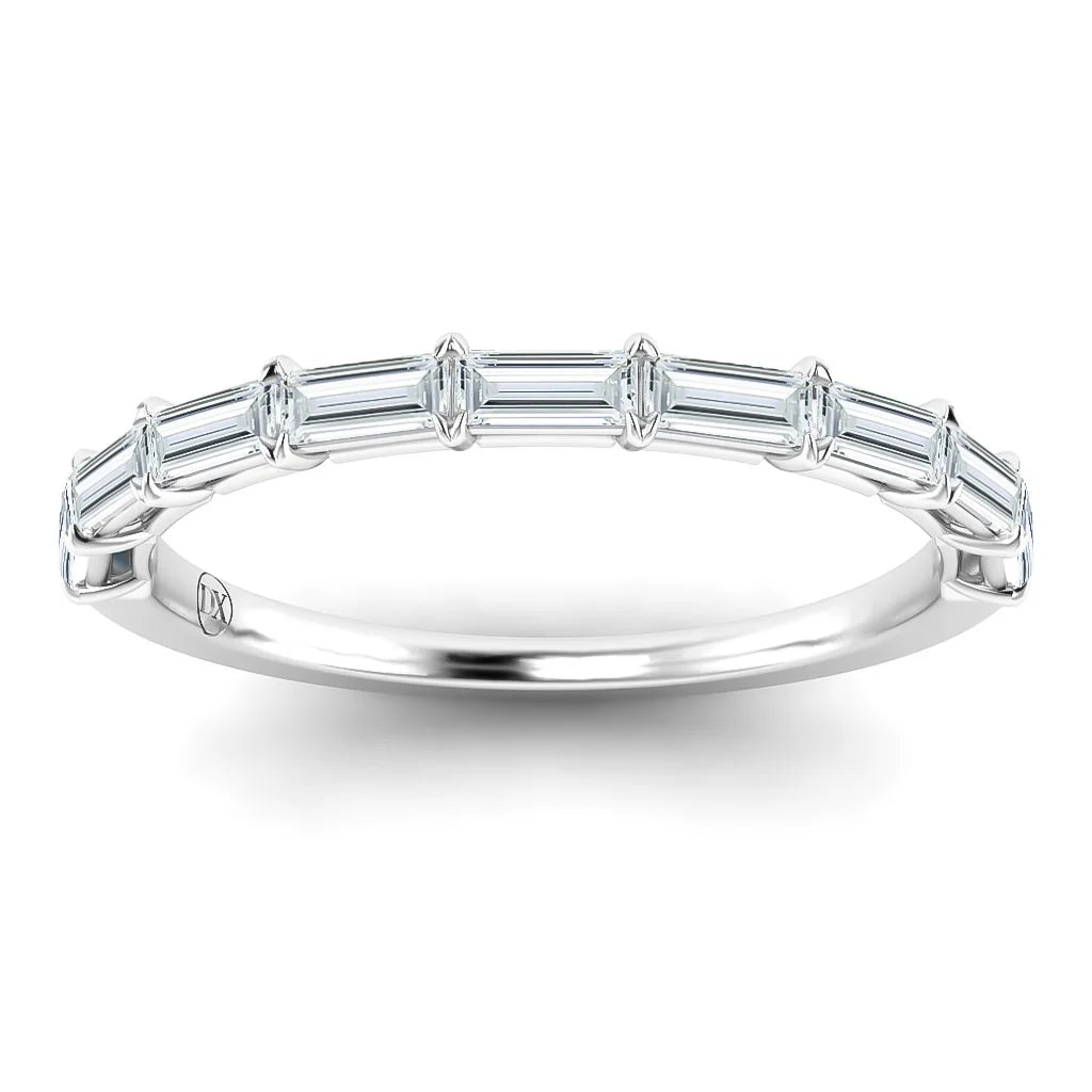 A white gold ring with a row of seven baguette-cut diamonds set along the top of the band.
