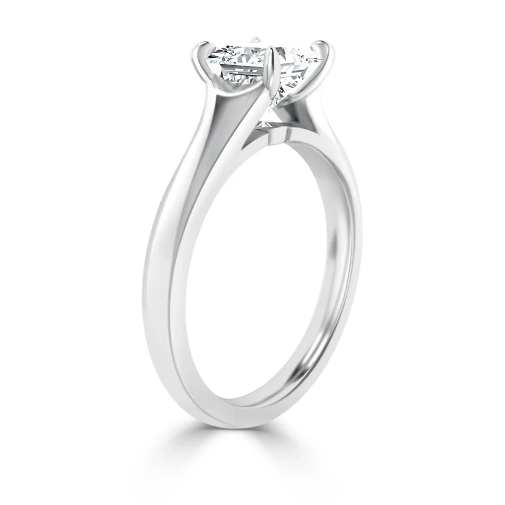 A silver solitaire ring with a round-cut diamond in a four-prong setting, displayed on a white background.