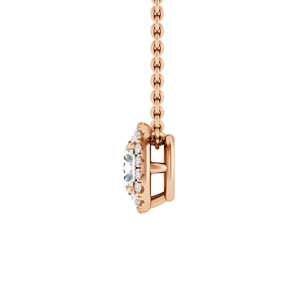Side view of a rose gold chain necklace with a round, diamond-studded pendant setting against white background.