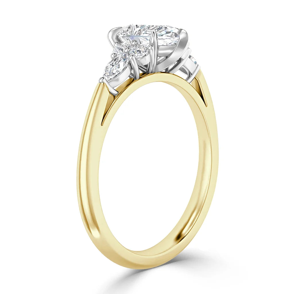 Gold ring with a large round diamond center stone and two smaller side diamonds in a white gold setting.