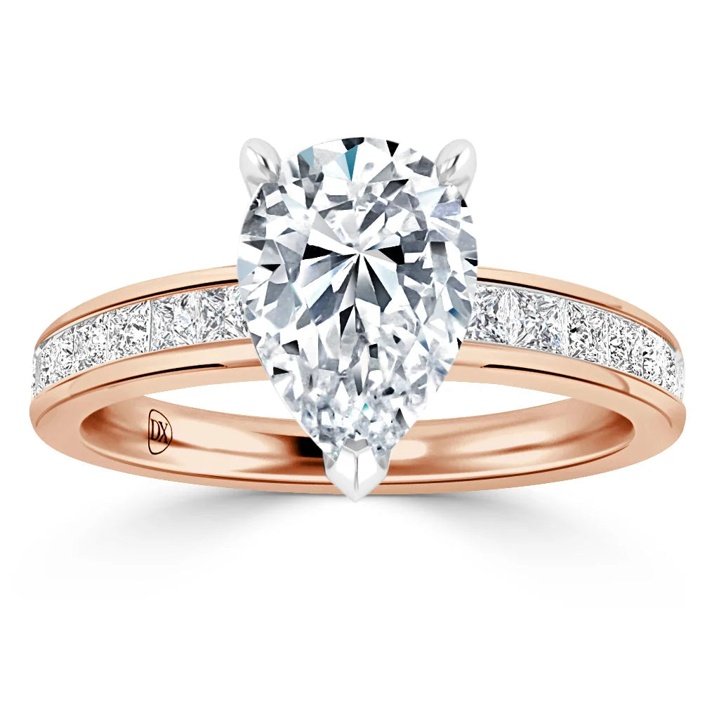 A rose gold ring with a large pear-shaped diamond and smaller diamonds along the band on a white background.