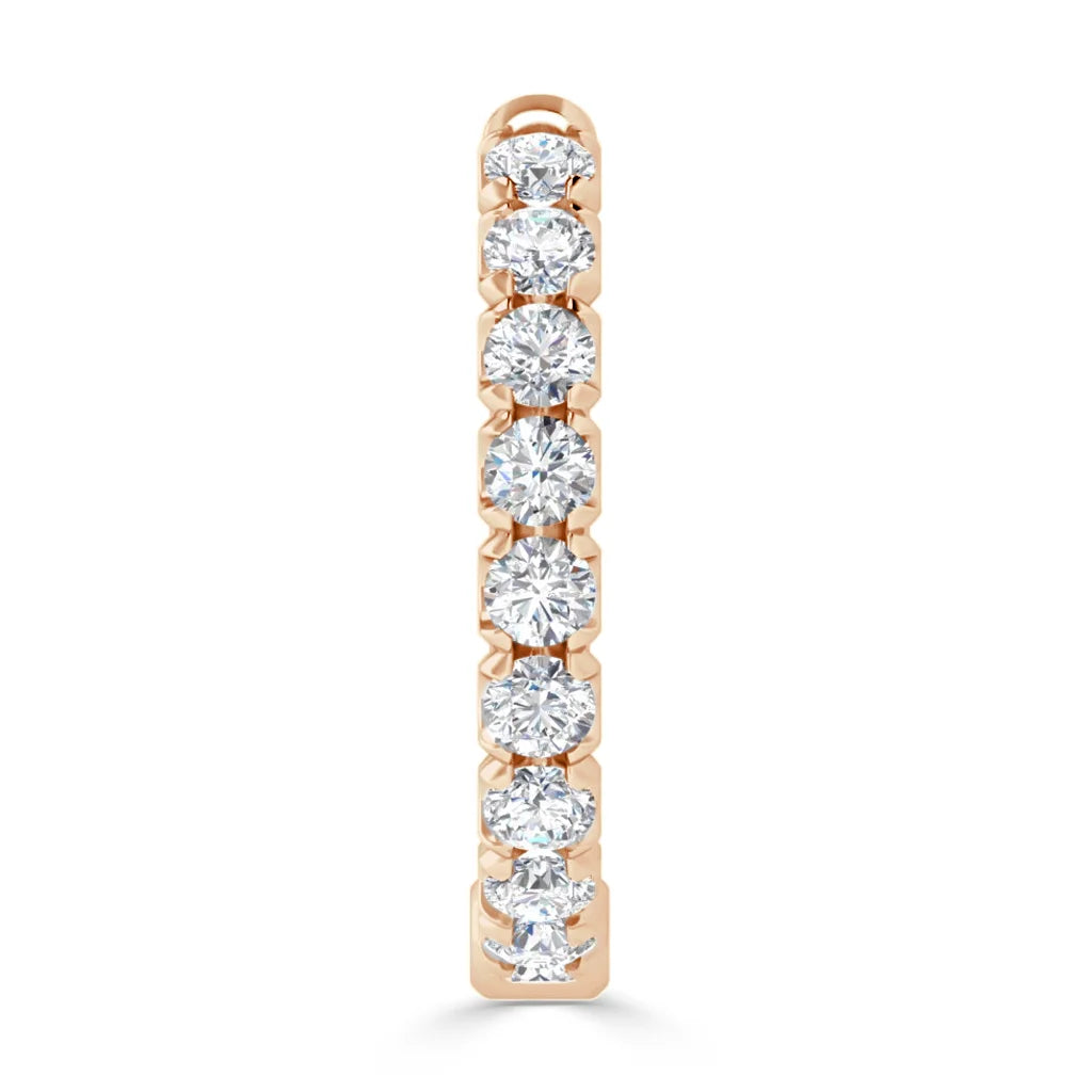 A gold bar pendant set with seven round, sparkling diamonds in a vertical row on a white background.