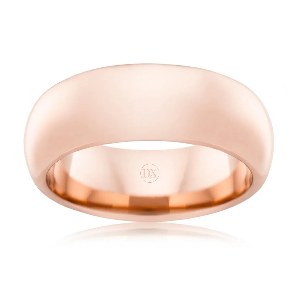 A plain, polished rose gold wedding band with a smooth finish and a subtle DX engraved inside.