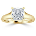 Gold ring with a large, square-cut diamond solitaire in a four-prong setting on a smooth band.