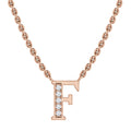 A gold chain necklace with a letter F pendant adorned with small, sparkling diamonds.