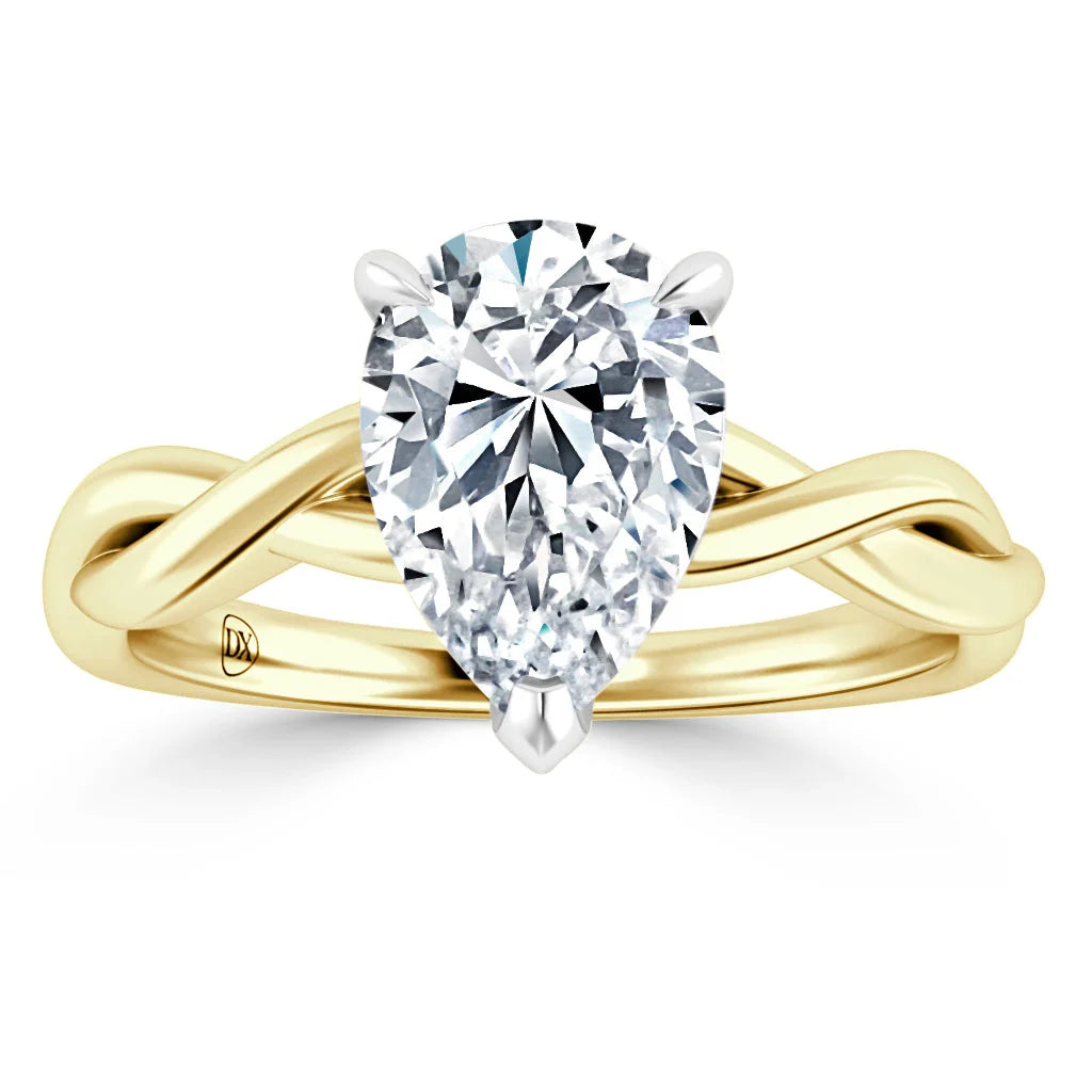 Gold ring with a twisted band design featuring a large pear-shaped diamond at the center.