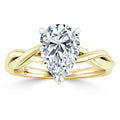 Gold ring with a twisted band design featuring a large pear-shaped diamond at the center.