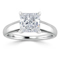 A princess-cut diamond solitaire ring with a sleek, polished white gold band and four prongs.