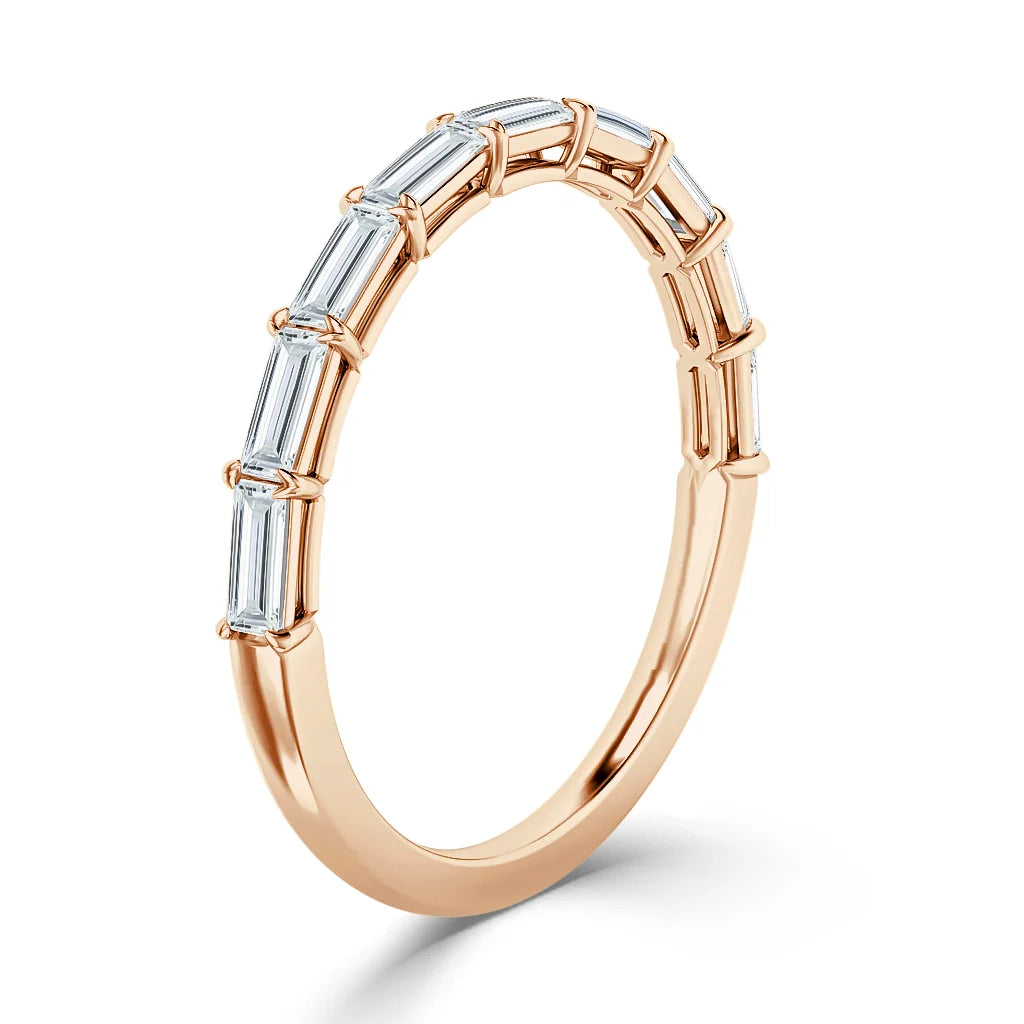 A rose gold ring set with six vertical baguette-cut diamonds across the top half of the band.