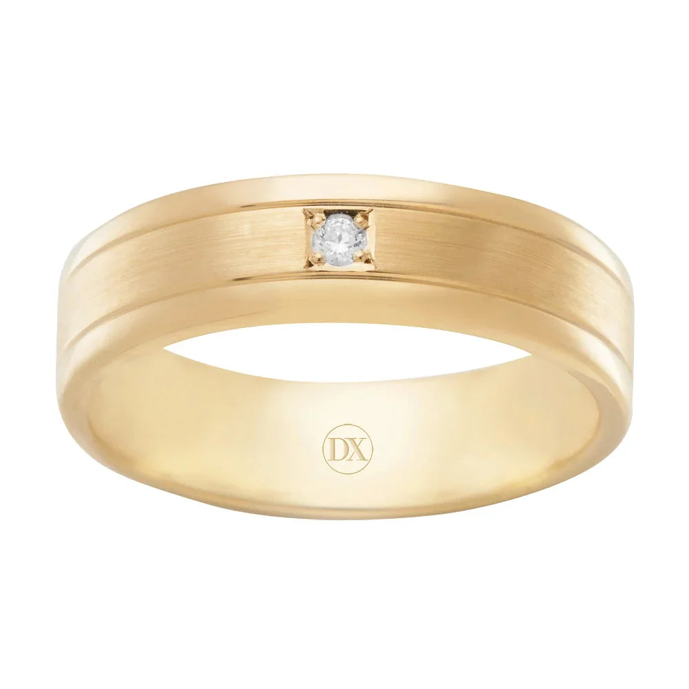 Gold band ring with a small central diamond set in a square setting, and “DX” engraved inside.