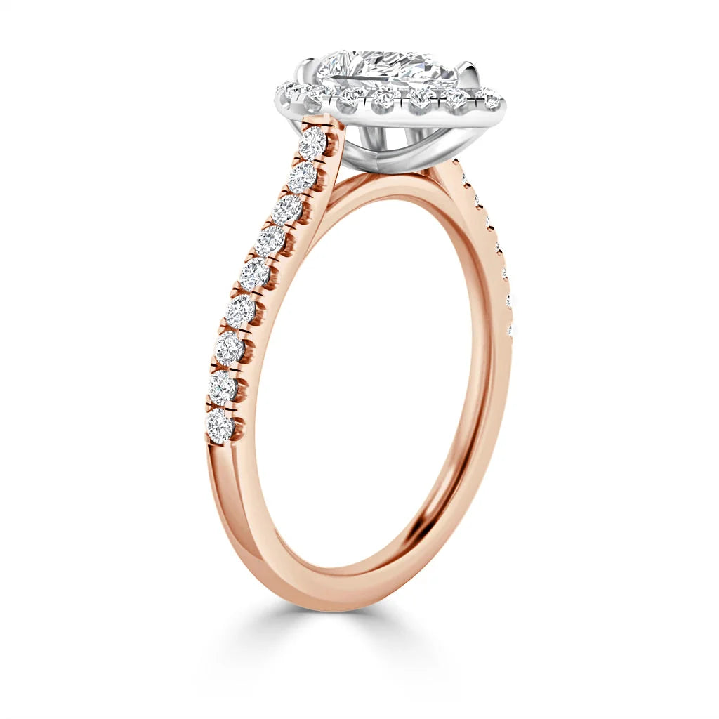 A rose gold ring with a round diamond center stone and small diamonds along the band, shown in side view.