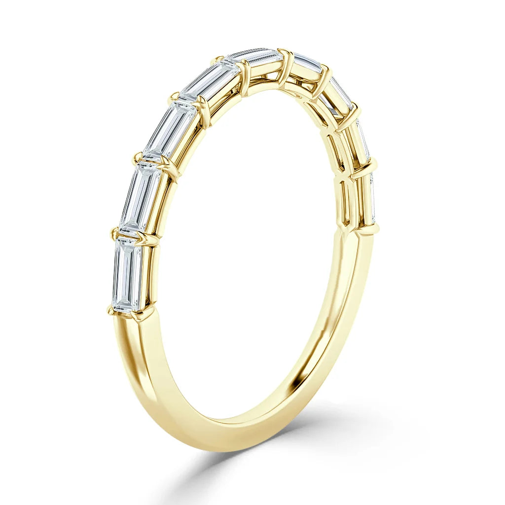 Gold ring with a row of rectangular baguette-cut diamonds set along the upper half of the band.