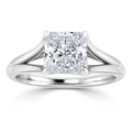 Platinum ring with a large, radiant-cut square diamond held by four prongs and a split shank band.