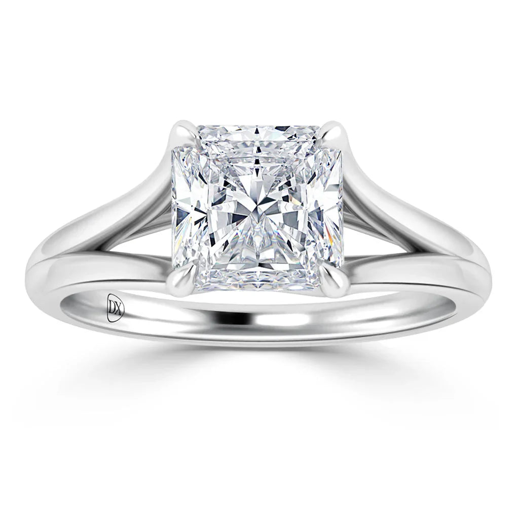 Platinum ring with a large, radiant-cut square diamond held by four prongs and a split shank band.