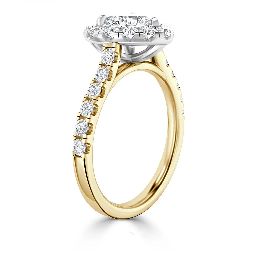 Gold engagement ring with round center diamond, halo setting, and diamonds along the band, on white background.