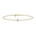 Delicate gold chain bracelet with a single round diamond in a bezel setting at the center.