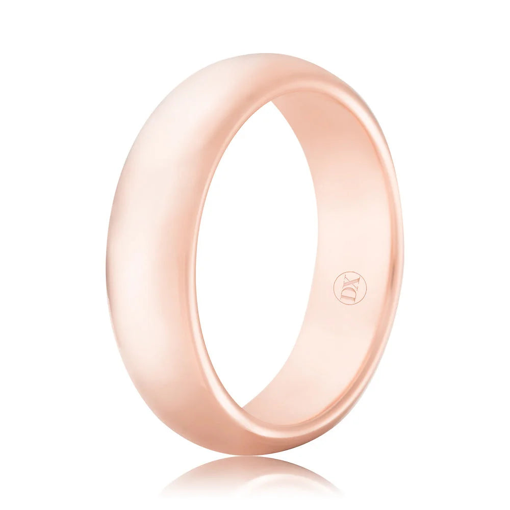 A plain, polished rose gold band ring with a smooth surface and a small engraved logo on the inside.