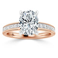 Rose gold ring with an oval diamond center stone and smaller diamonds set along the band.