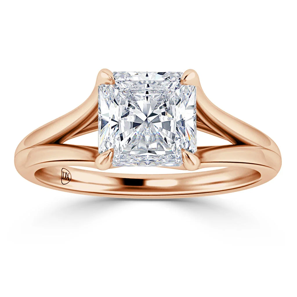 Rose gold ring with a large, radiant princess-cut diamond set in four prongs on a split band.