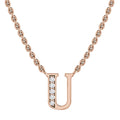 Rose gold necklace with a U pendant, left side adorned with small sparkling gemstones.