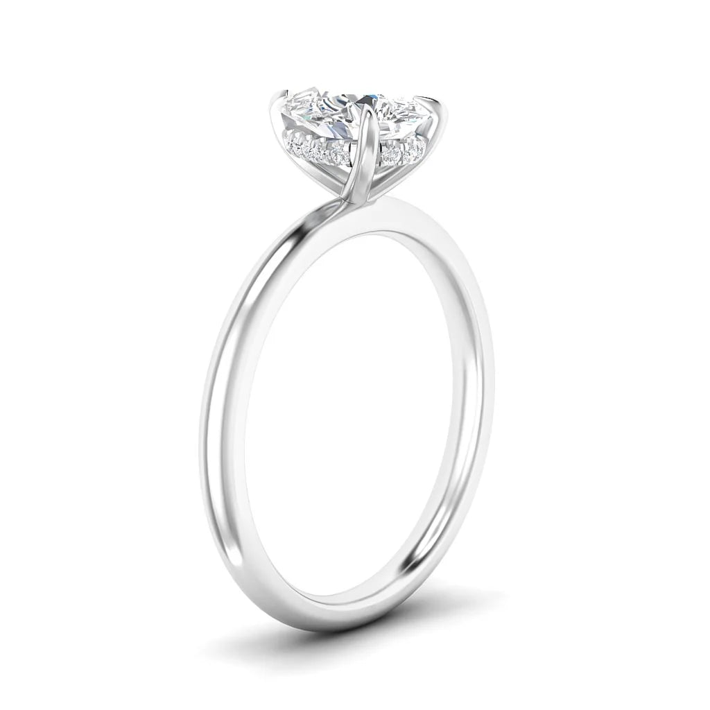 A white gold solitaire ring with a round diamond in a prong setting, viewed from the side.
